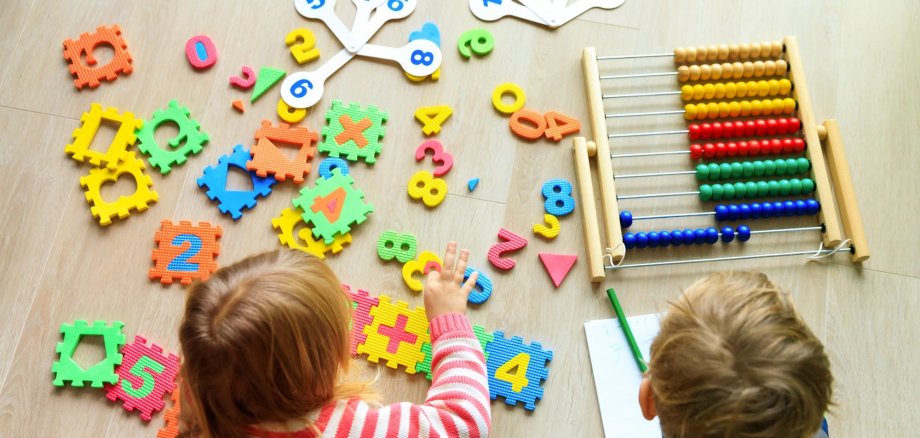 little boy and girl learn to write and calculate numbers